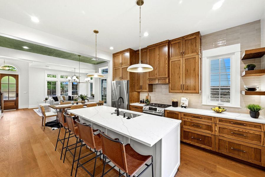 A grand entrance sets the stage for this open-concept culinary space, featuring natural wood cabinetry and a generously sized island. A grand entrance sets the stage for this open-concept culinary space, featuring natural wood cabinetry and a generously sized island.