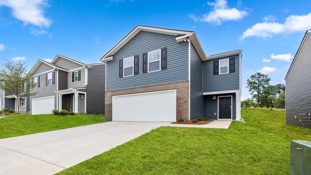 Front exterior of a new home in Paddock Point, Roebuck, SC, highlighting curb appeal (Image 2).
