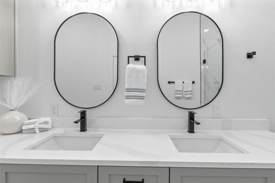 Double vanity with white quartz countertops and integrated sinks