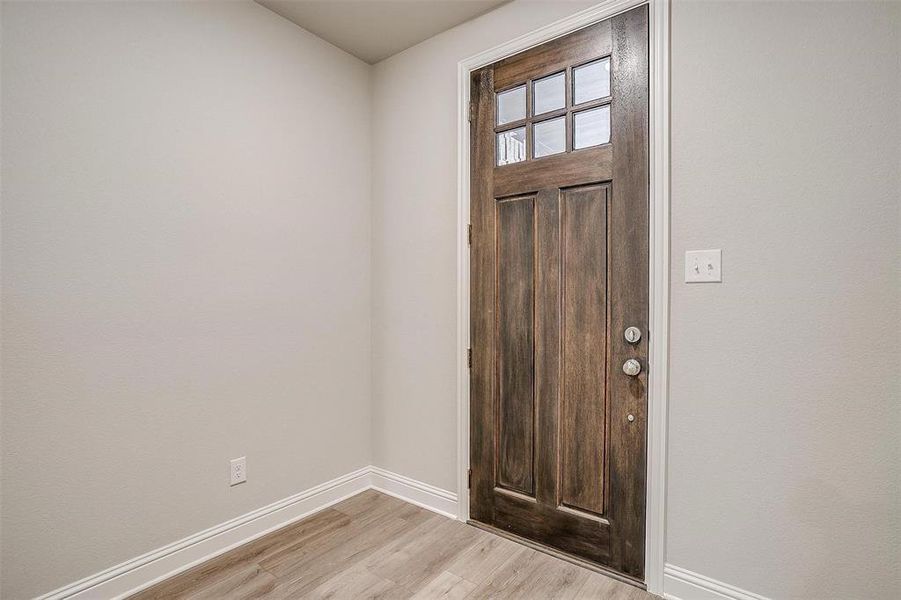 Entrance foyer featuring light hardwood / wood-style floors