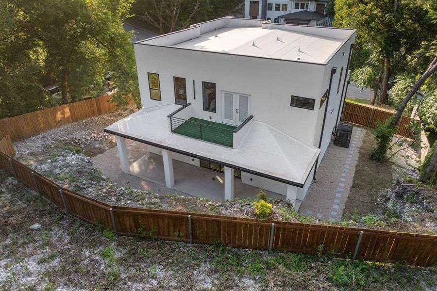 Rear view of property featuring a fenced backyard, a patio, stucco siding, and french doors