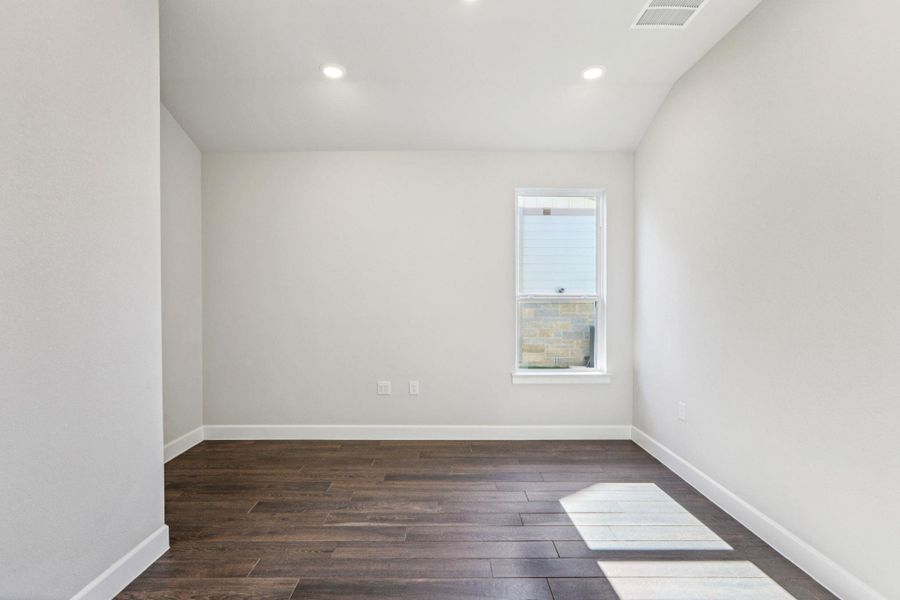Spare room featuring dark wood-style flooring and recessed lighting Spare room featuring dark wood-style flooring and recessed lighting