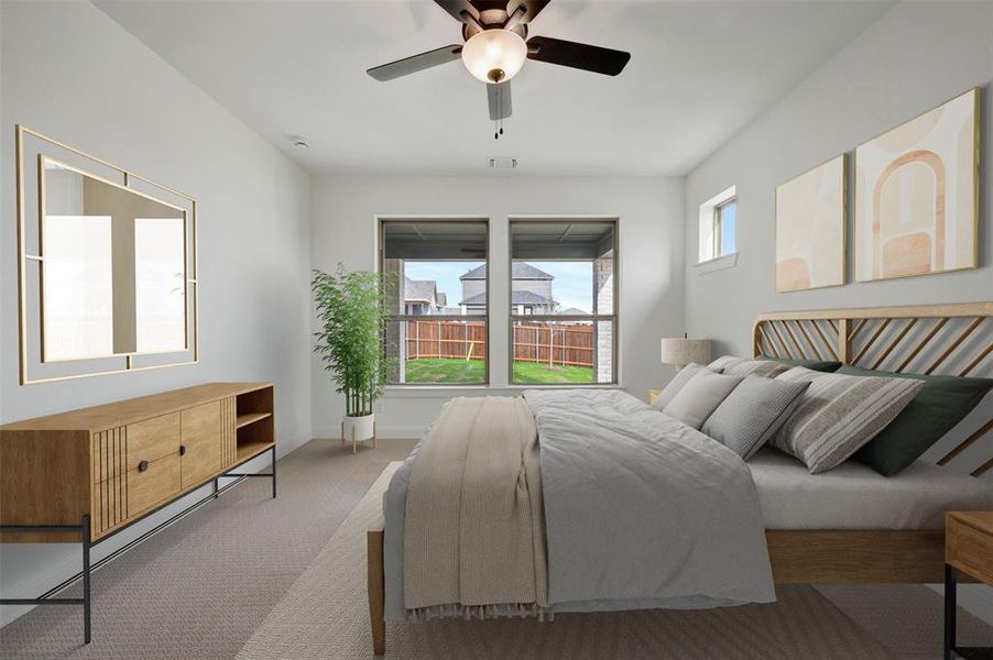 Bedroom with a ceiling fan and carpet flooring
