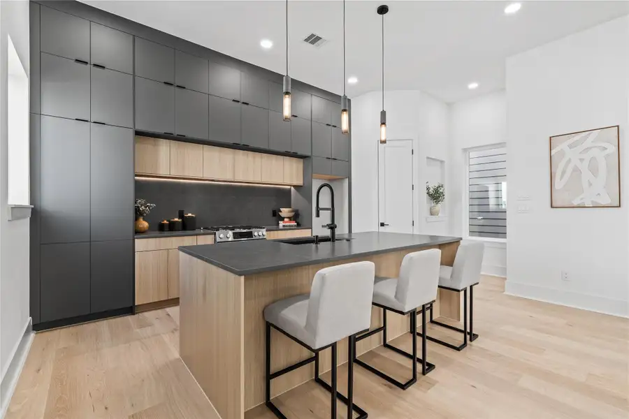 This kitchen is a masterclass in balance—striking the perfect harmony between form and utility. Floor-to-ceiling custom cabinetry maximizes vertical storage without compromising the room’s minimalist elegance, while the matte black detailing offers a grounded, contemporary edge. Every line feels intentional, every finish bespoke—a kitchen designed for both culinary performance and visual impact. This kitchen is a masterclass in balance—striking the perfect harmony between form and utility. Floor-to-ceiling custom cabinetry maximizes vertical storage without compromising the room’s minimalist elegance, while the matte black detailing offers a grounded, contemporary edge. Every line feels intentional, every finish bespoke—a kitchen designed for both culinary performance and visual impact.