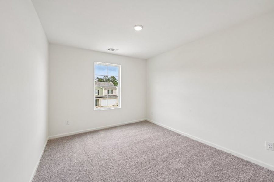 A room with a window and carpet. A room with a window and carpet.