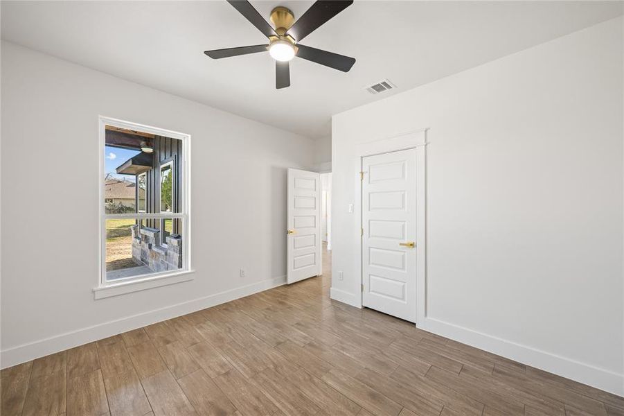 Unfurnished bedroom with wood finished floors and a ceiling fan