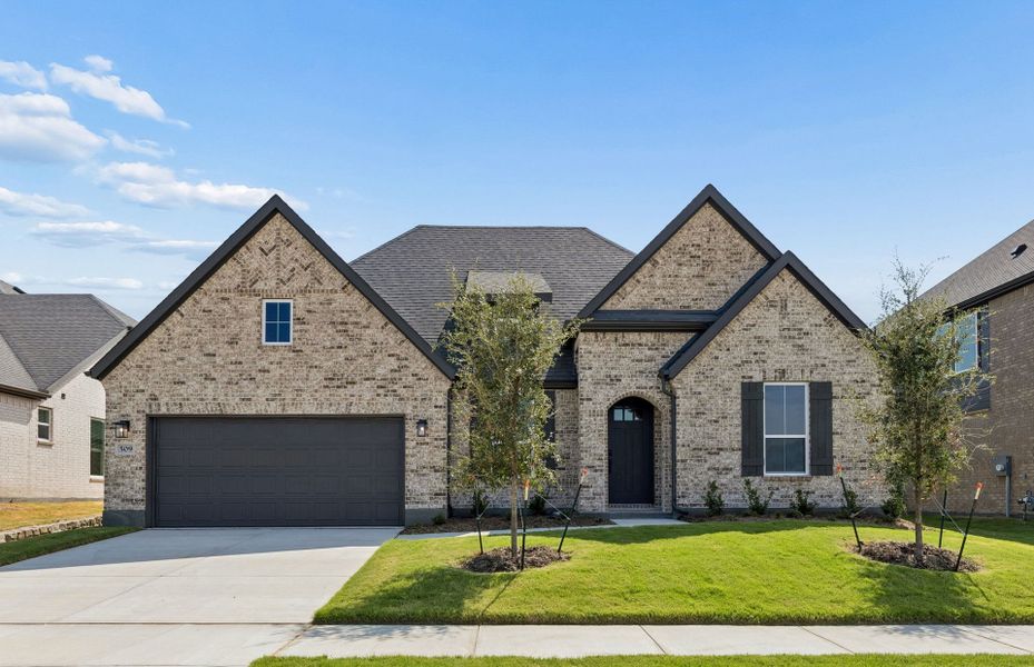 Front exterior of a new home in Overland Grove, Forney, TX, highlighting curb appeal (Image 1). Front exterior of a new home in Overland Grove, Forney, TX, highlighting curb appeal (Image 1).