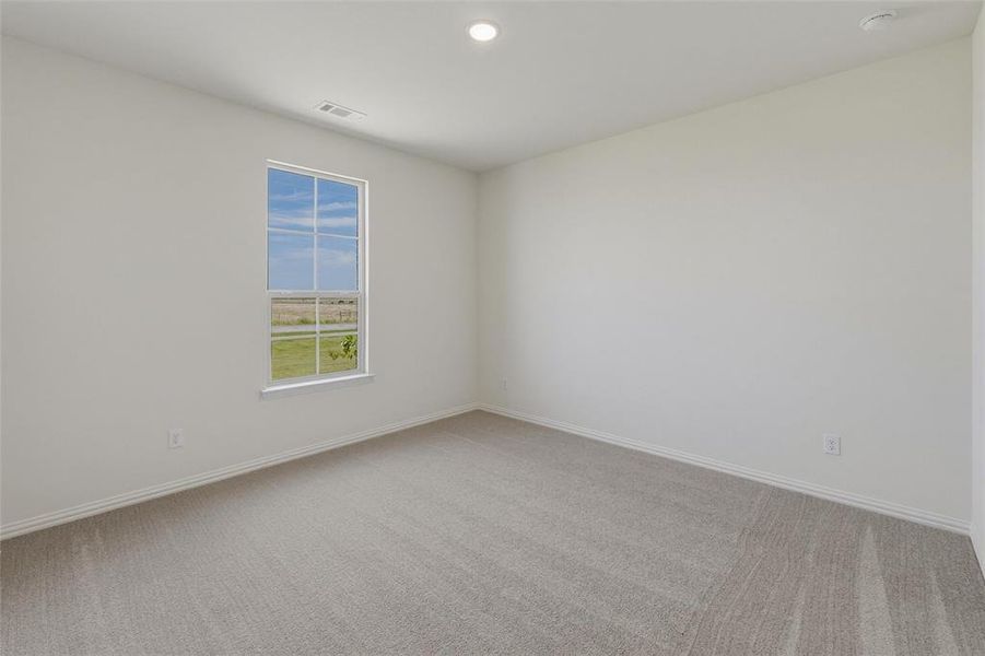 Spacious room with a single window providing natural light Spacious room with a single window providing natural light