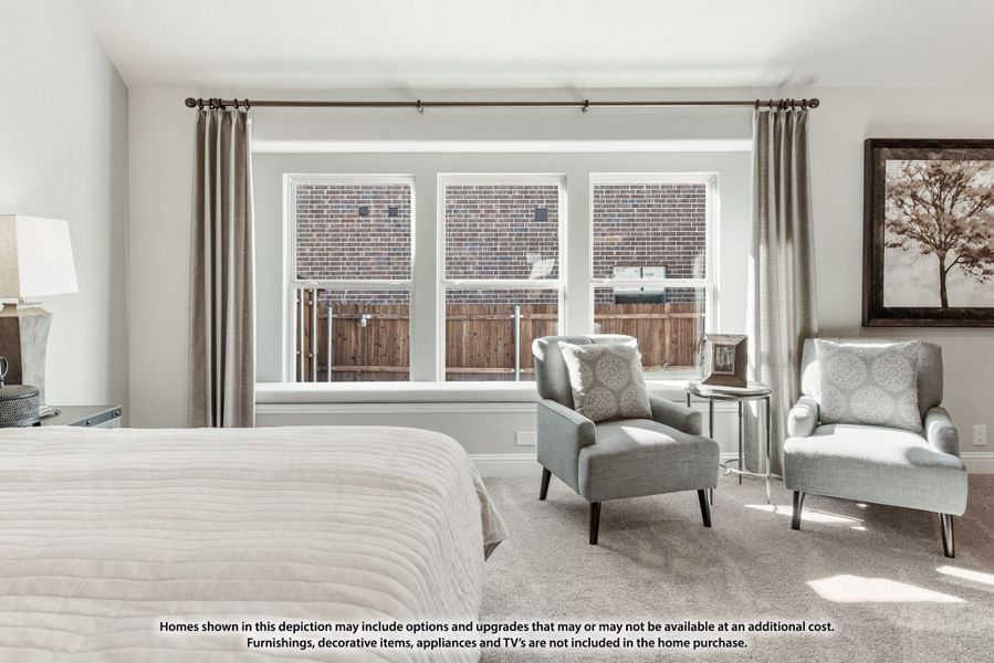 Bedroom with two gray accent chairs, triple windows with drapes, and carpeted floors
