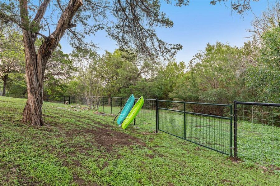 This back gate leads to a small trail that gets you to the cove of Lake Whitney! Grab a kayak and have some fun!