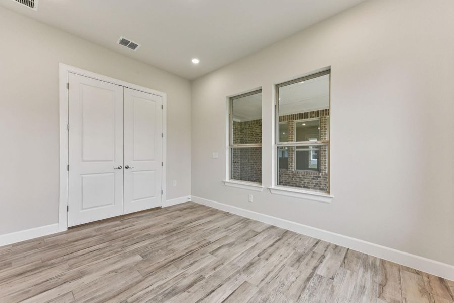 Unfurnished bedroom with light wood-style floors, a closet, and recessed lighting