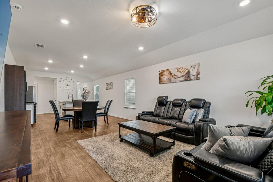 Living area featuring recessed lighting, wood finished floors, and lofted ceiling