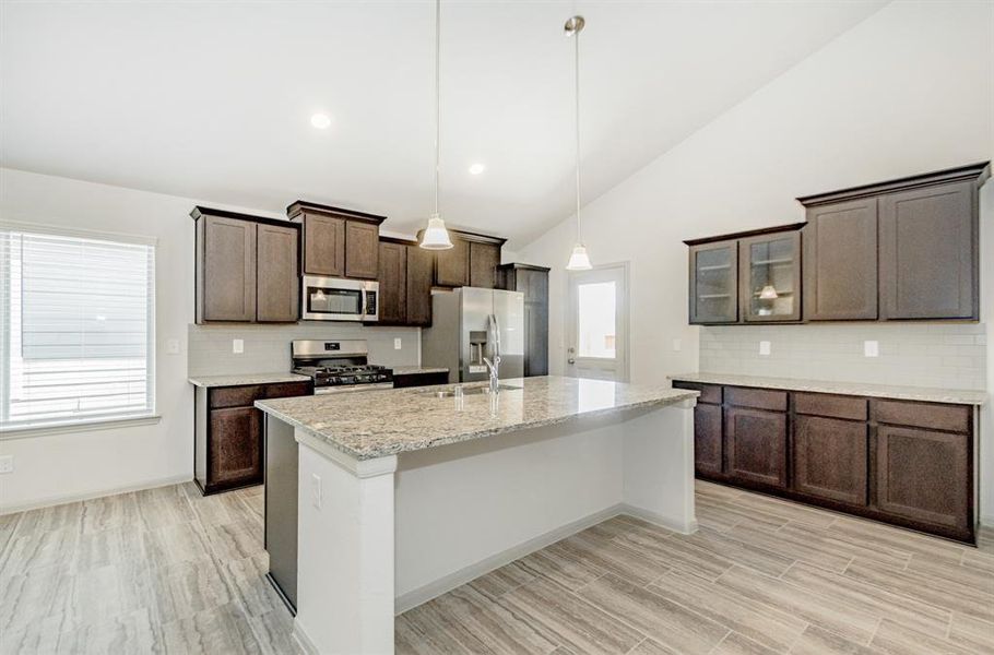 The centerpiece of the kitchen, this oversized island provides the perfect space for meal prep, casual dining, or gathering with loved ones. Featuring elegant quartz countertops and a stainless-steel sink, this island is both beautiful and practical. Combined with dark cabinetry and modern pendant lighting, the kitchen is a masterpiece of form and function. Cooking and entertaining have never been this stylish or seamless!