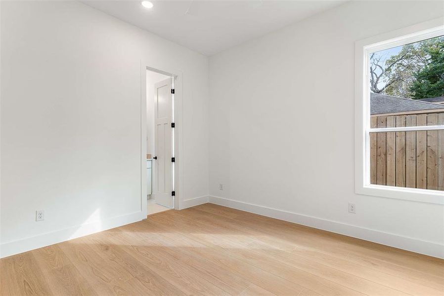Spare room featuring light wood finished floors and recessed lighting