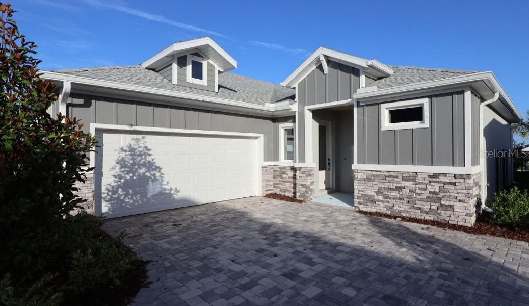Front exterior of a new home in Waterset Bungalow Series, Apollo Beach, FL, highlighting curb appeal (Image 1). Front exterior of a new home in Waterset Bungalow Series, Apollo Beach, FL, highlighting curb appeal (Image 1).