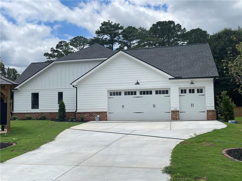 Front exterior of a new home in , Monroe, GA, highlighting curb appeal (Image 1).