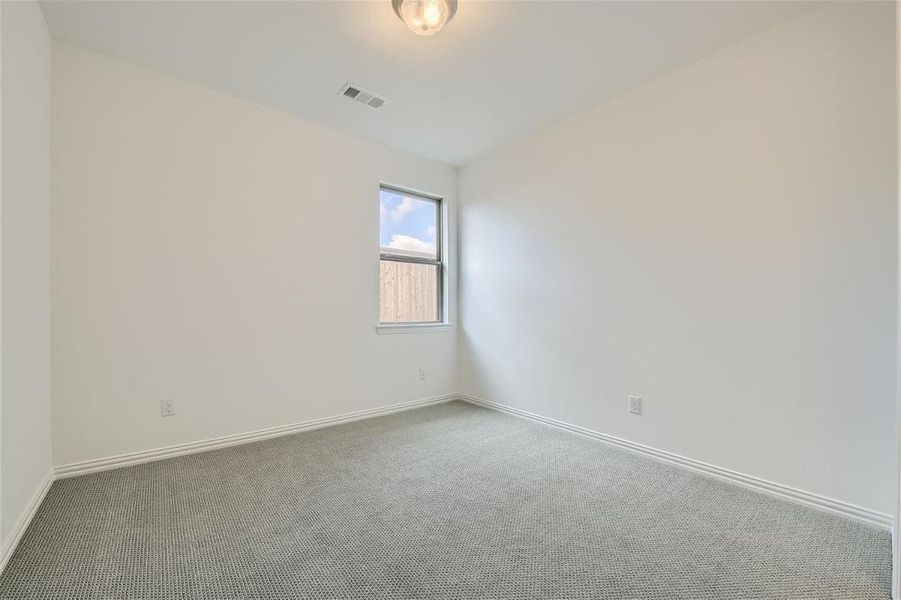 Spare room featuring carpet flooring