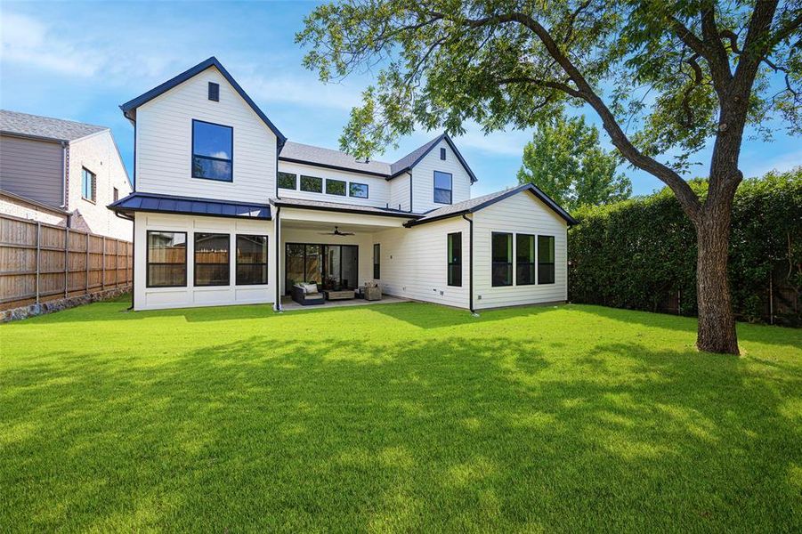 Rear view of property featuring a standing seam roof, ceiling fan, a metal roof, and an outdoor living space Rear view of property featuring a standing seam roof, ceiling fan, a metal roof, and an outdoor living space