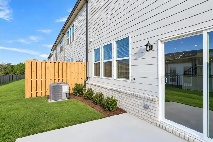 Exterior details and patio area of a home in Towns at Holly Springs, Holly Springs (Image 3).