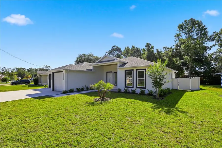 Front exterior of a new home in , Palm Coast, FL, highlighting curb appeal (Image 2). Front exterior of a new home in , Palm Coast, FL, highlighting curb appeal (Image 2).