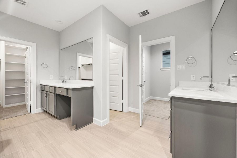 Enjoy your luxurious spa-style bath with dual vanities and an oversized walk-in shower for a true daily escape. Image depicts similar floorplan in another ROC Homes Community. Enjoy your luxurious spa-style bath with dual vanities and an oversized walk-in shower for a true daily escape. Image depicts similar floorplan in another ROC Homes Community.