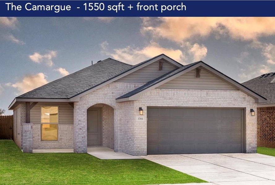 View of front of home featuring a garage and a lawn