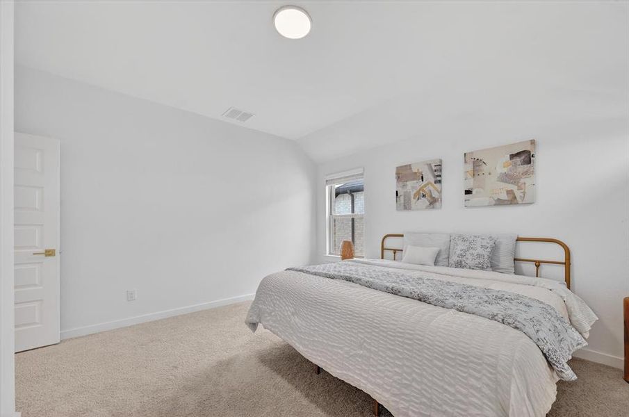 Bright interior space featuring a window, light-colored walls, and neutral carpeting