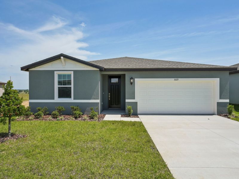 Front exterior of a new home in Benton Hills - Classic Series, Brooksville, FL, highlighting curb appeal (Image 1). Front exterior of a new home in Benton Hills - Classic Series, Brooksville, FL, highlighting curb appeal (Image 1).