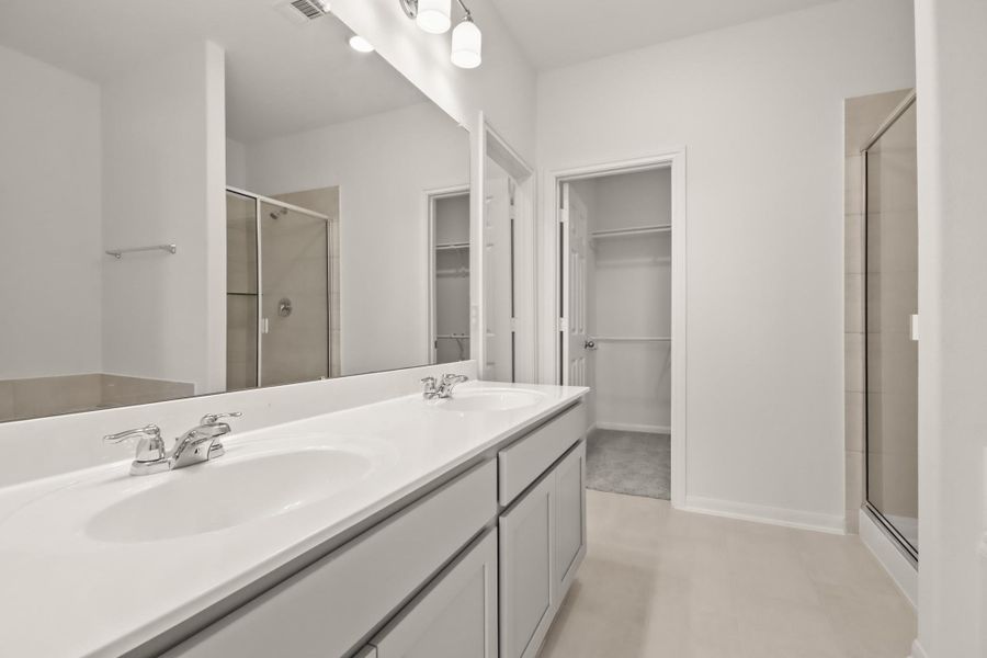 The en-suite bathroom offers a spa-like atmosphere with its elegant design, high end finishes, and tasteful lighting, creating a retreat within your own home. The en-suite bathroom offers a spa-like atmosphere with its elegant design, high end finishes, and tasteful lighting, creating a retreat within your own home.