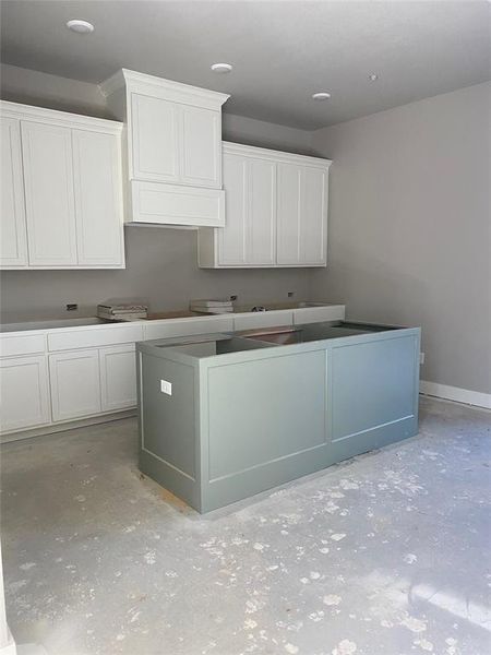 Kitchen with white cabinets and a center island