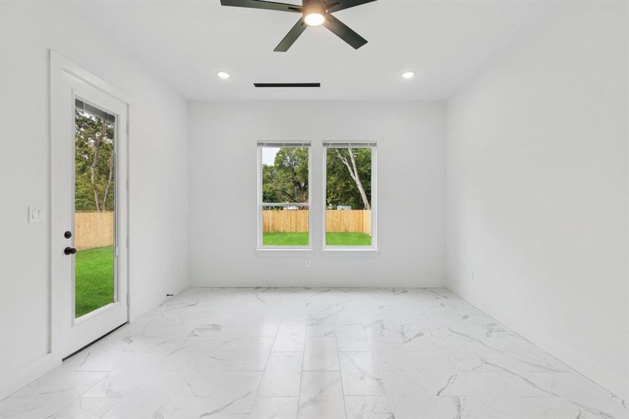 Unfurnished room with marble look tile flooring, recessed lighting, and ceiling fan