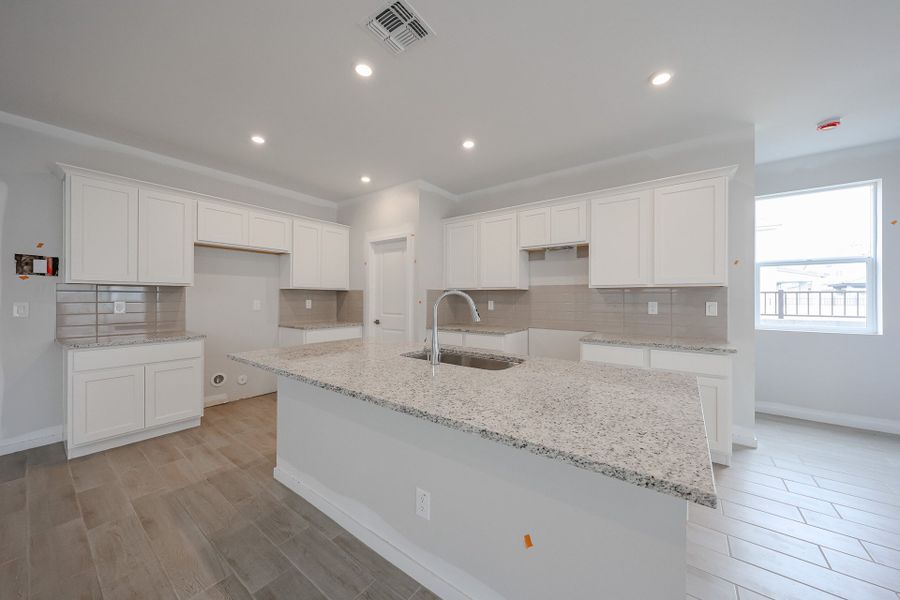 A kitchen with white cabinets. A kitchen with white cabinets.
