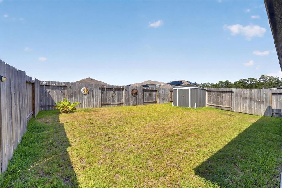 Spacious fully fenced backyard offers plenty of usable lawn space for relaxing, entertaining, gardening and more. Spacious fully fenced backyard offers plenty of usable lawn space for relaxing, entertaining, gardening and more.