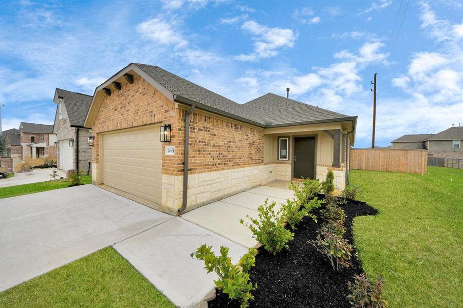 The residence features a practical 2-car garage complemented by a generous driveway, ensuring abundant space for parking needs.