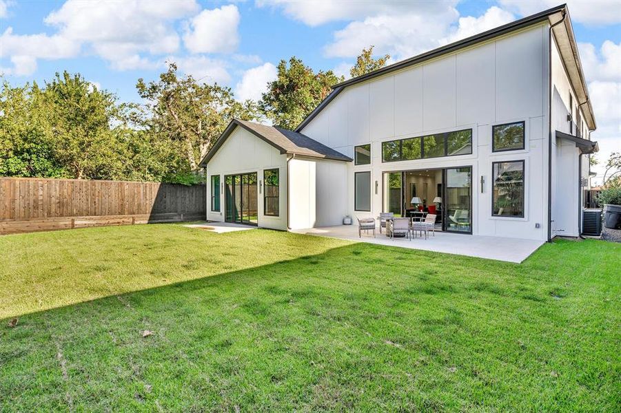 Rear view of property with a fenced backyard and a patio Rear view of property with a fenced backyard and a patio