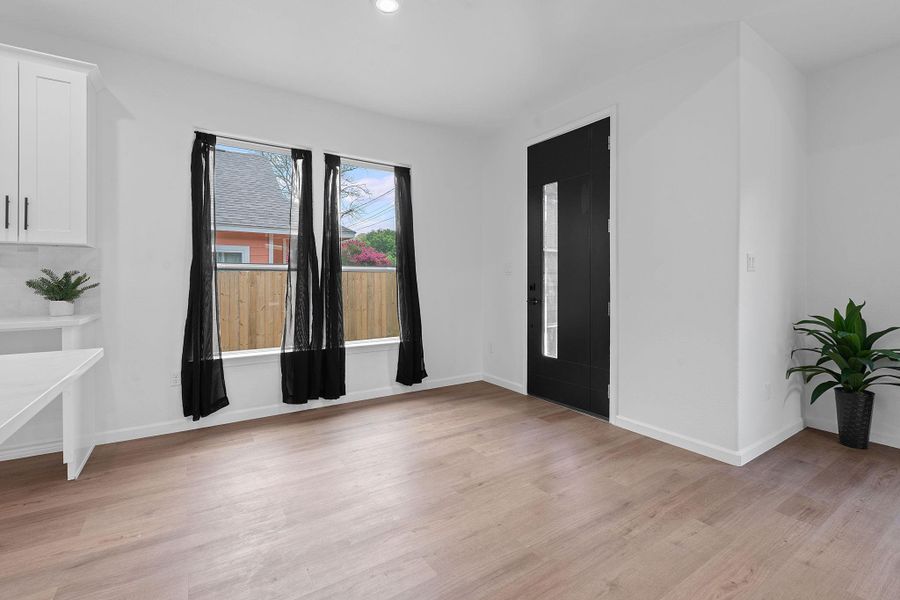 Entryway with light wood-style floors and recessed lighting