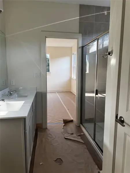 Bathroom featuring a shower stall and double vanity Bathroom featuring a shower stall and double vanity
