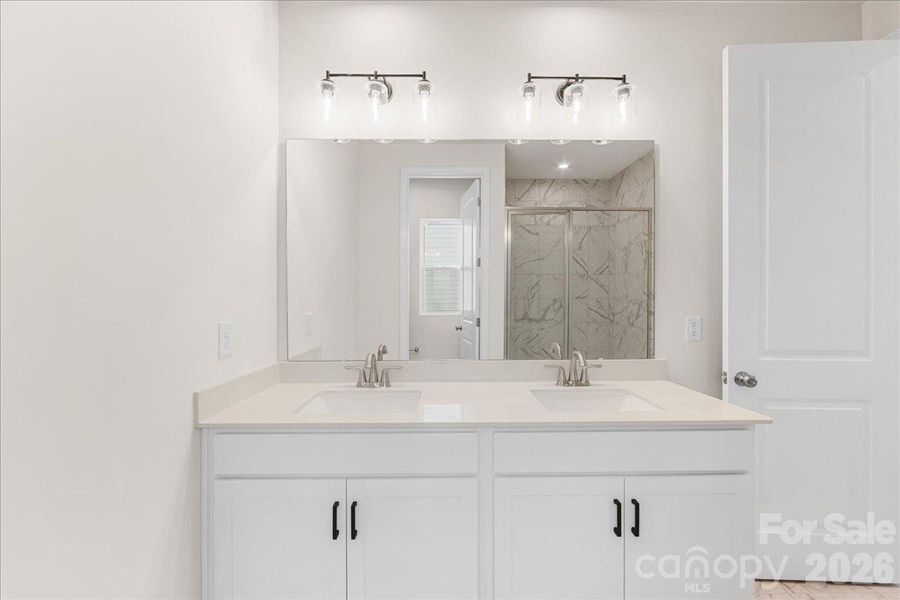 Dual Vanity at Primary Bath with Convenient Storage.