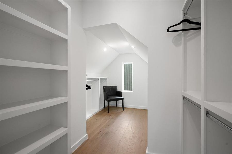 This is one huge primary walk-in closet with hidden storage areas.