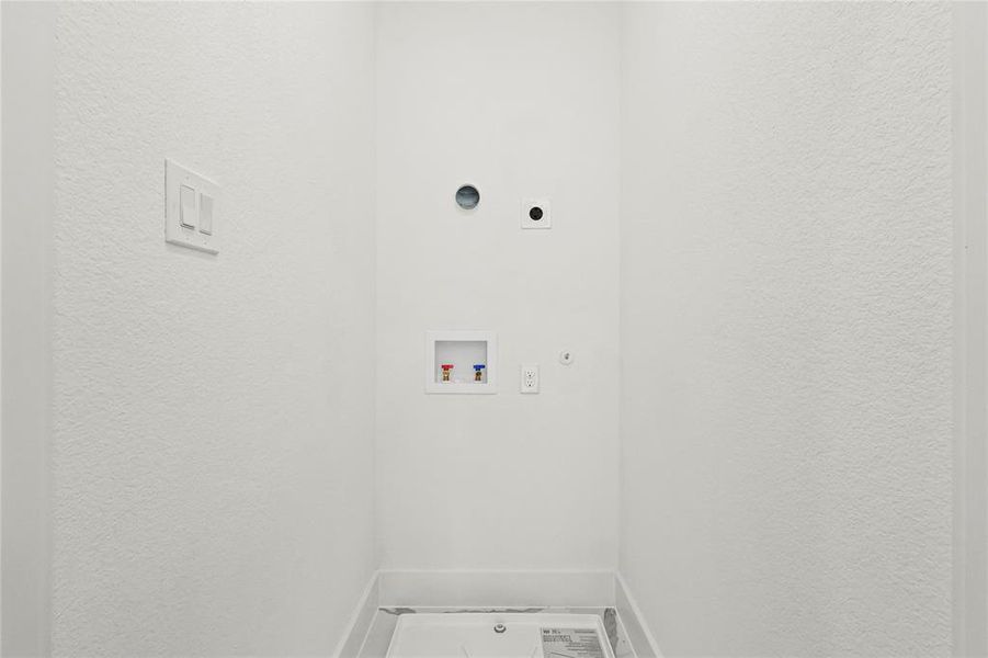 Washroom with hookup for a washing machine, hookup for a gas dryer, and electric dryer hookup