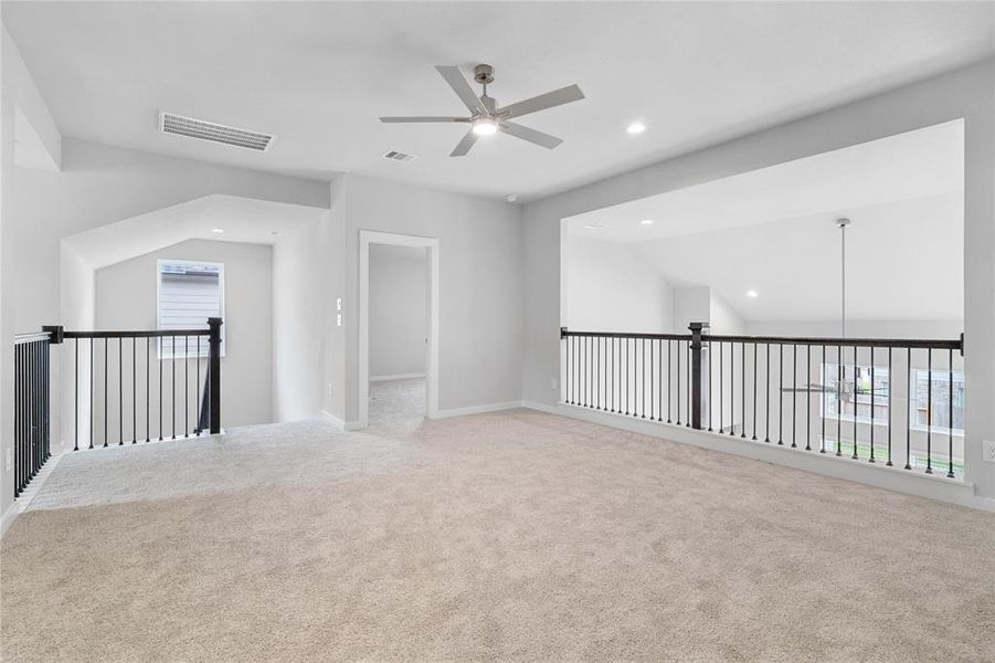 Another view of the game room looking into a secondary bedroom with its own private access to a secondary bathroom.