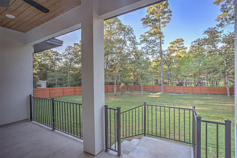 Balcony featuring a ceiling fan and view of backyard Balcony featuring a ceiling fan and view of backyard