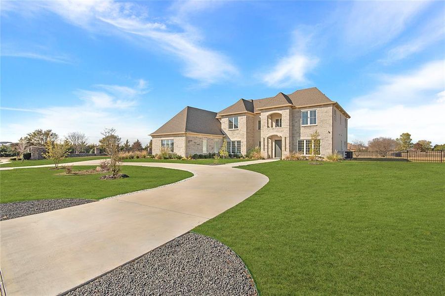 French provincial home with curved driveway and brick siding French provincial home with curved driveway and brick siding