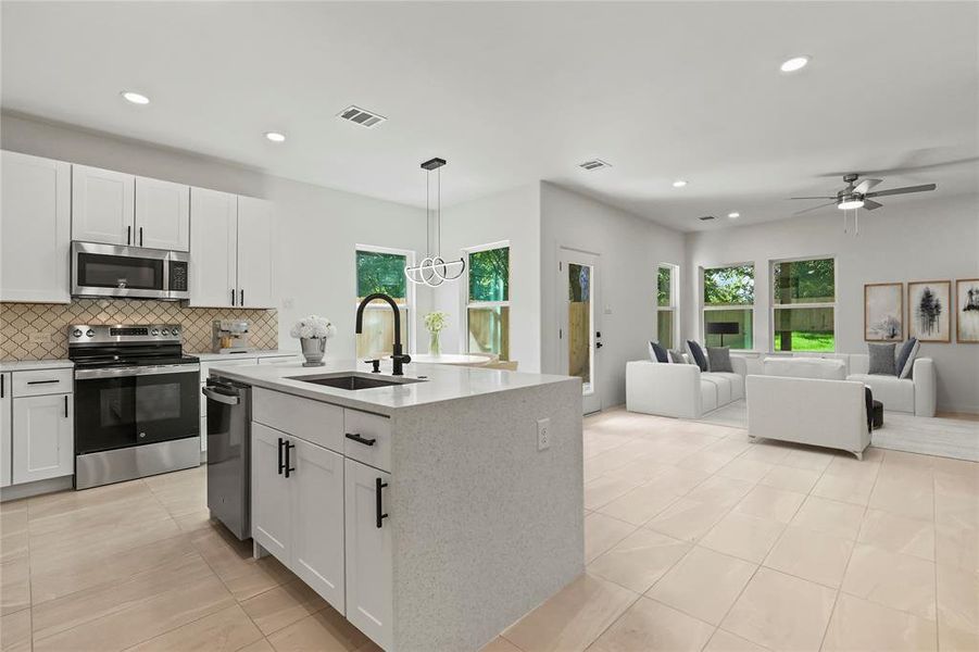 Kitchen with appliances with stainless steel finishes, light tile patterned flooring, white cabinets, backsplash, and recessed lighting