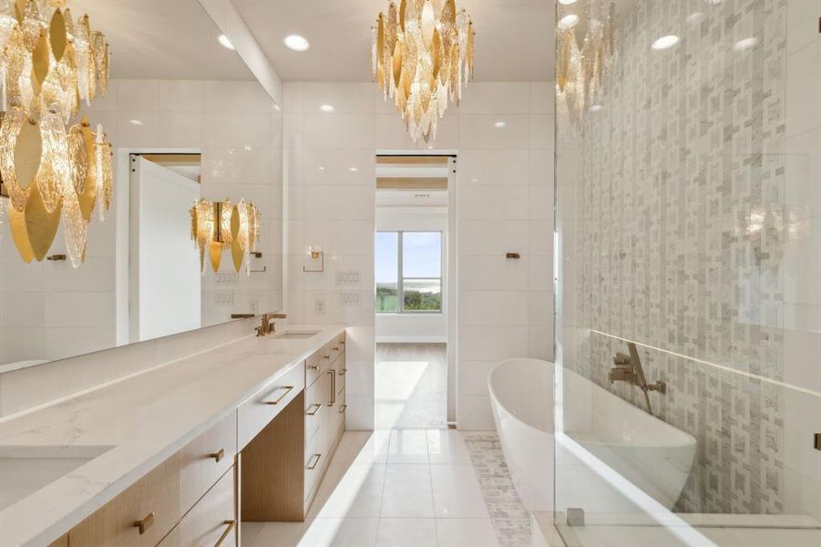 Full bathroom featuring tile walls, a soaking tub, double vanity, and tile patterned flooring