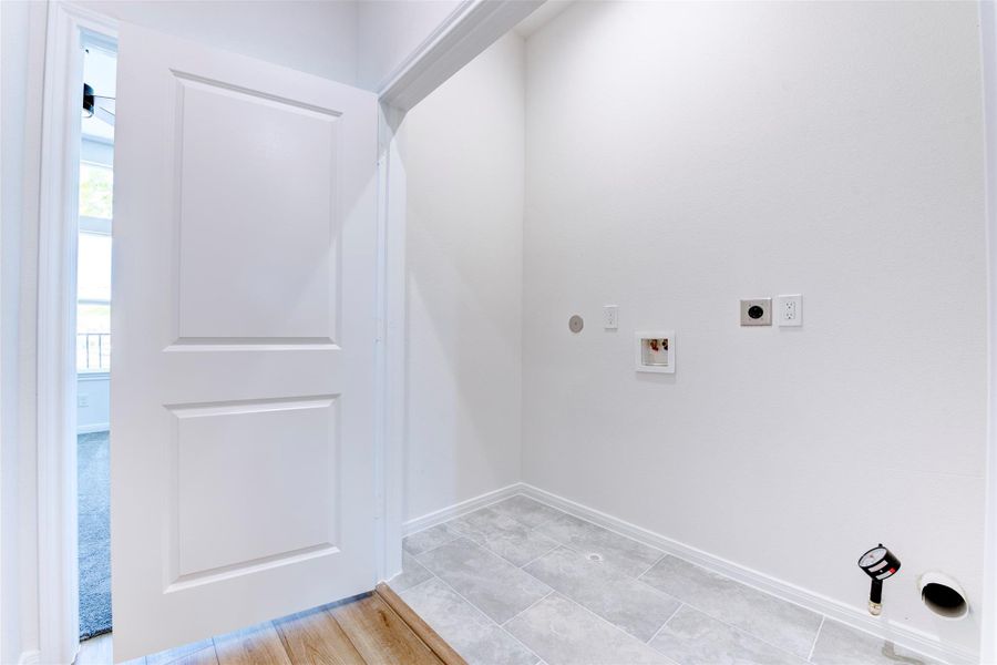 Laundry room conveniently located near the primary suite and in close proximity to all secondary bedrooms for added everyday ease.