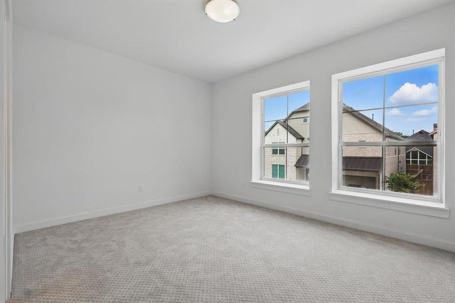 Carpeted empty room with baseboards