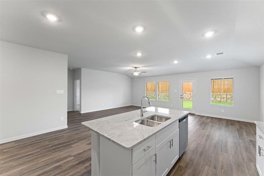 Kitchen featuring open floor plan, stainless steel dishwasher, ceiling fan, dark wood-type flooring, and recessed lighting Kitchen featuring open floor plan, stainless steel dishwasher, ceiling fan, dark wood-type flooring, and recessed lighting