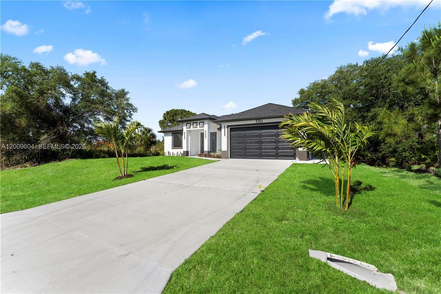 Front exterior of a new home in , Lehigh Acres, FL, highlighting curb appeal (Image 23).