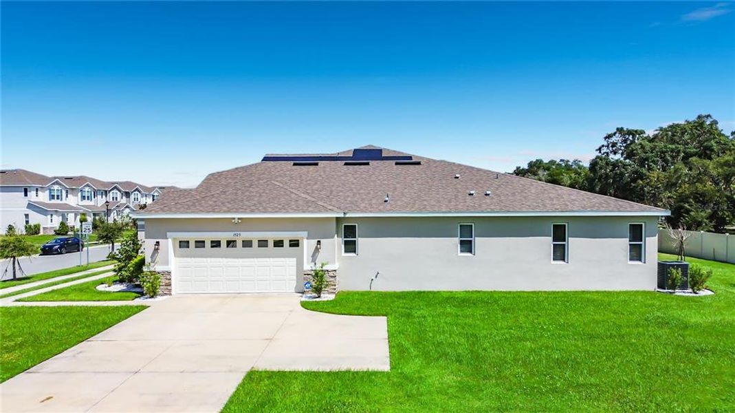 Front exterior of a new home in Seasons at Big Sky, Kissimmee, FL, highlighting curb appeal (Image 27).